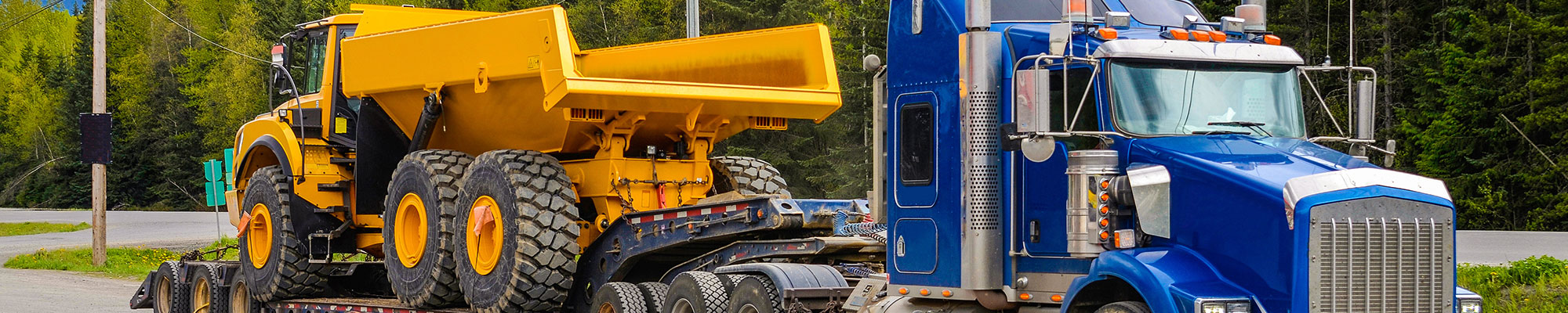 truck and lowboy trailer hauling an off-highway truck